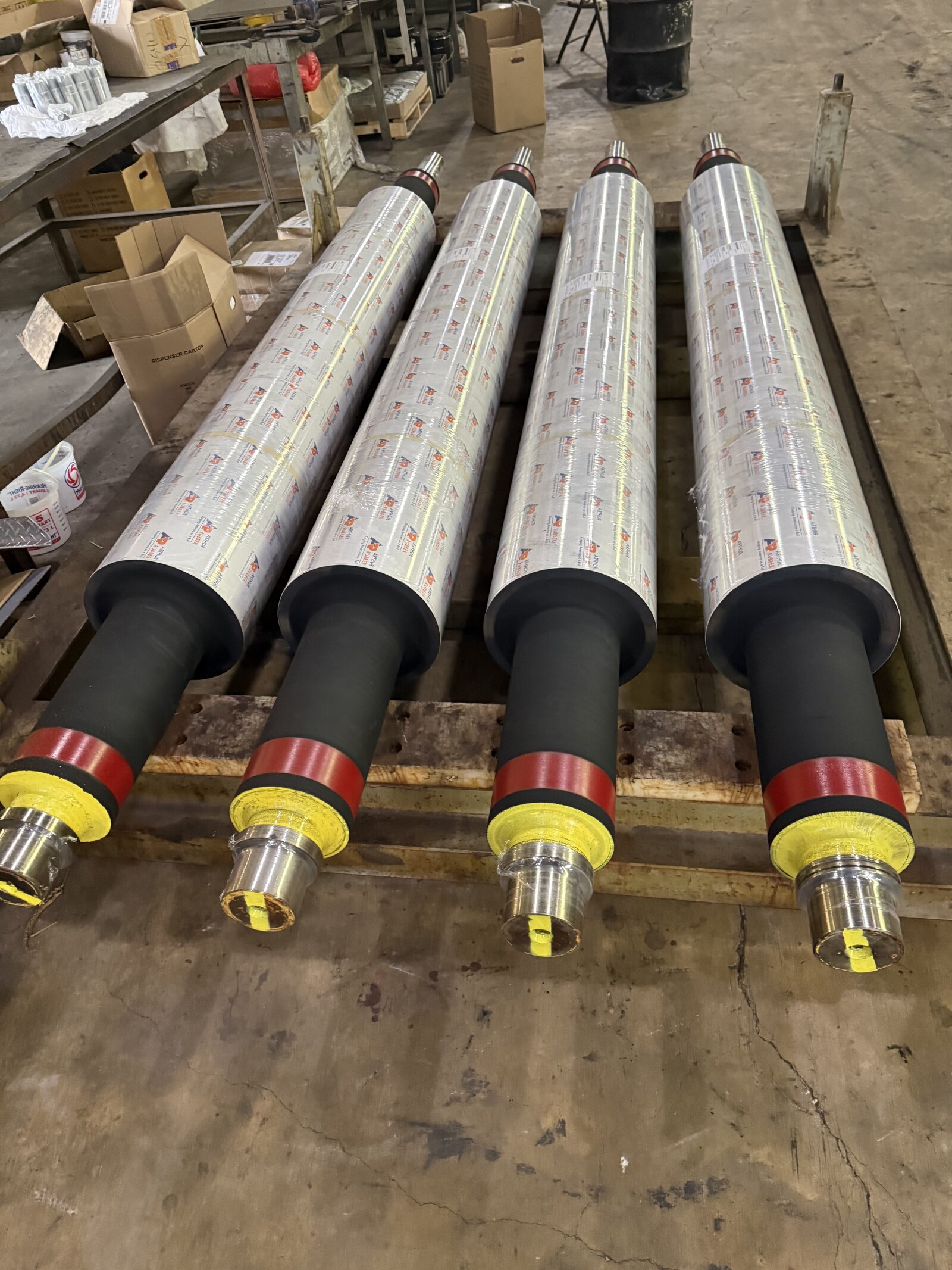 Four Arthur Rubber Black Diamond-covered rolls wrapped in branded shrink film, journal end protectors on, ready to ship