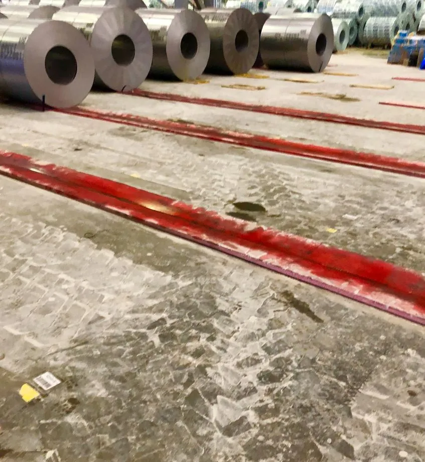 A mill row of steel coils on urethane floor pads