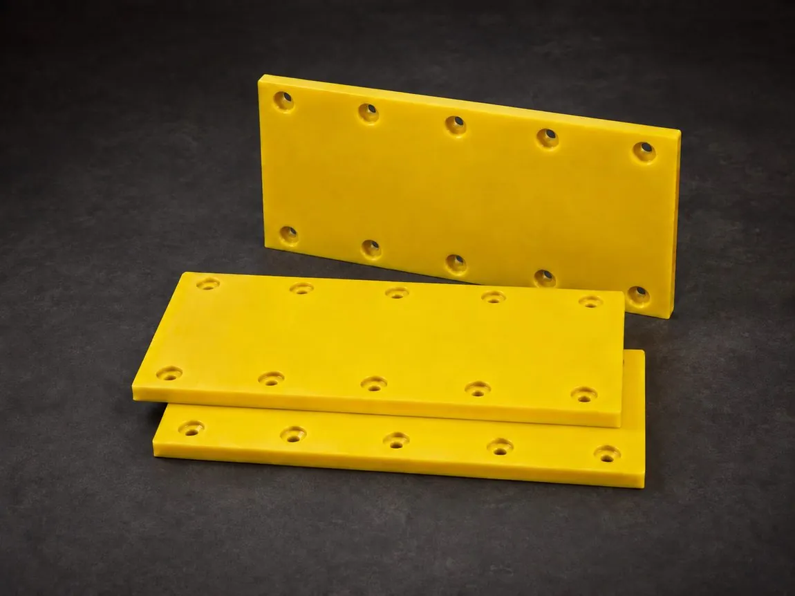 Safety-yellow cast urethane chute liner panels with countersunk bolt holes