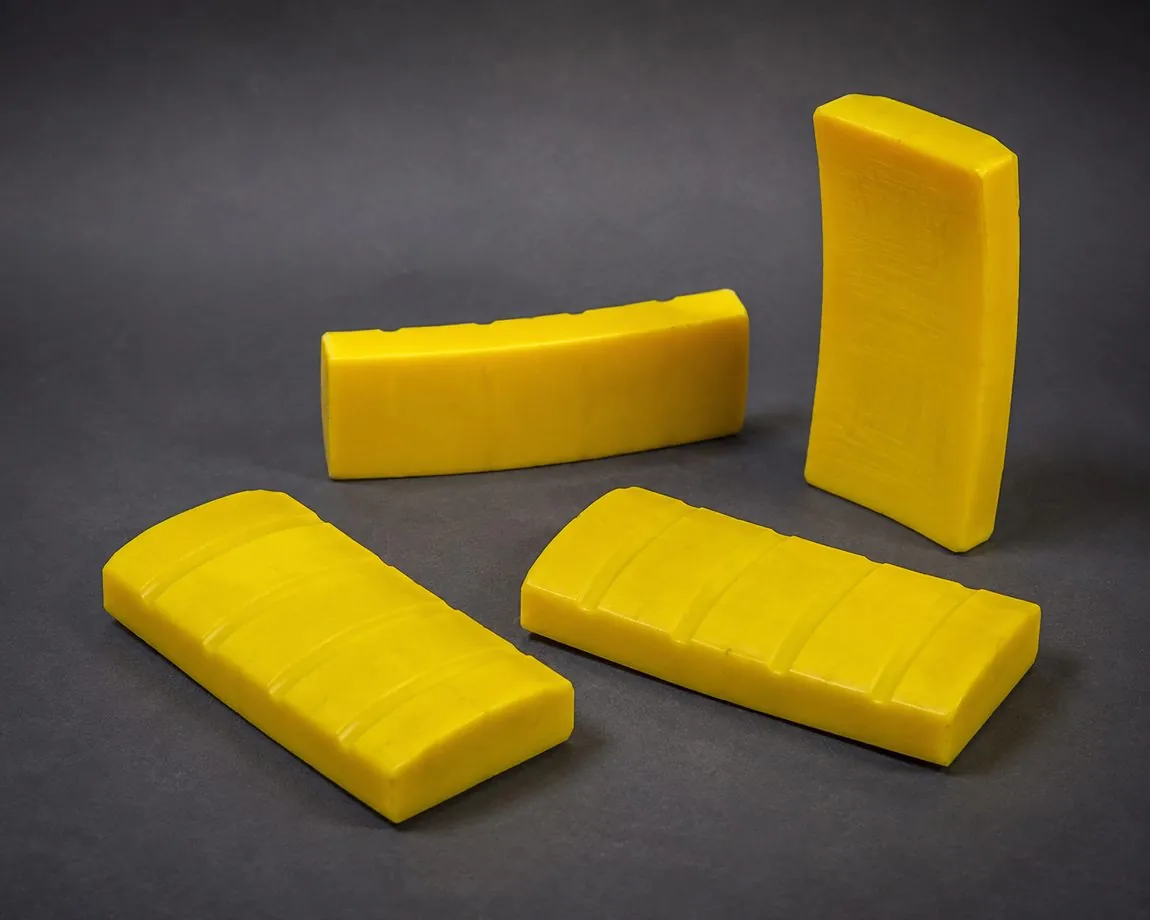 Safety-yellow cast urethane expander grip segments with curved ribbed faces