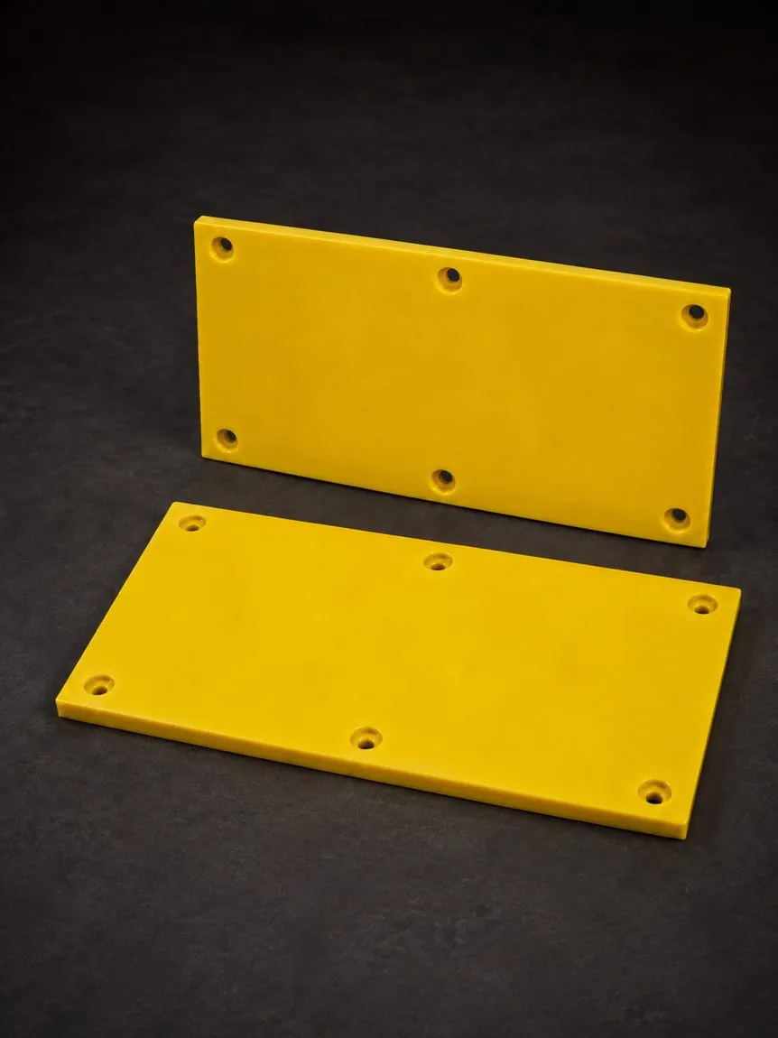 Safety-yellow cast urethane hopper and bin liner panels with bolt holes